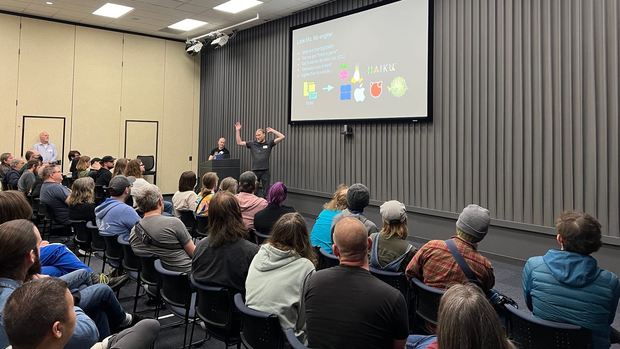 A picture from inside one of the sessions at Minnebar in which the speaker is talking about building games without a common engine.