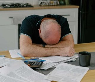 A frustrated man working on his taxes - Oleg Ivanov, Unsplash, posed by model