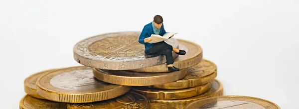A rich man sitting on a pile of huge gold coins - Mathieu Stern, Unsplash