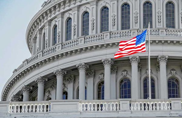 An American flag in frount of the US Capital - Getty Images - Unsplash