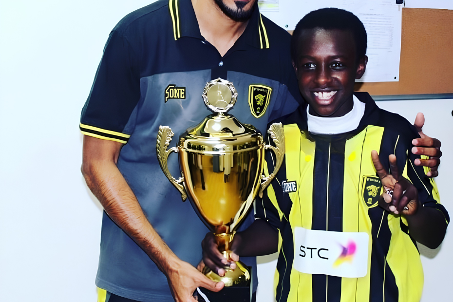A young Saud Abdulhamid pictured with a trophy he won in Al-Ittihad's youth ranks.