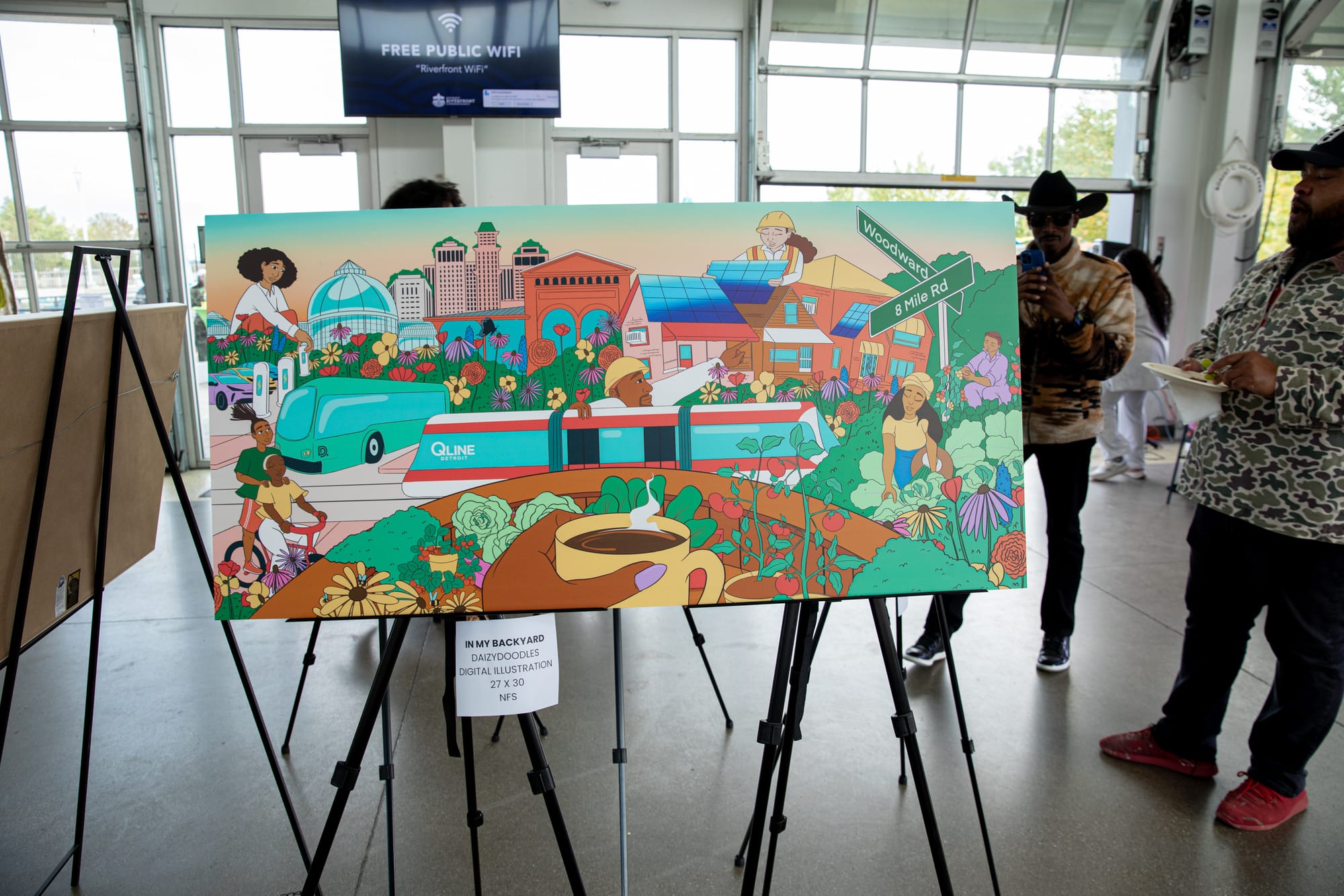 An animated artwork displayed on an easel, surrounded by other artworks and people walking around in a gallery space.