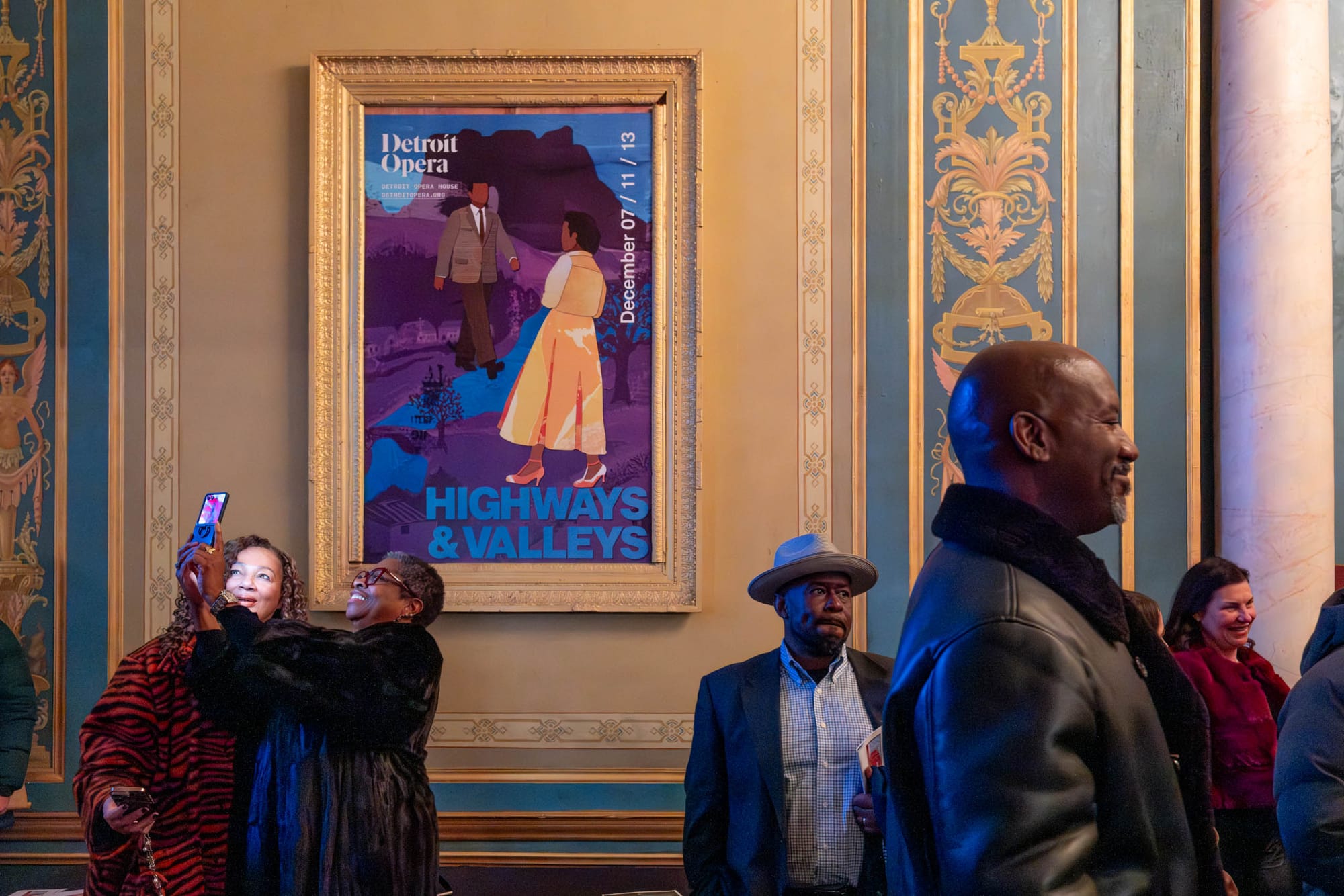 Several people stand in front of a poster that reads “Highways and Valleys.”