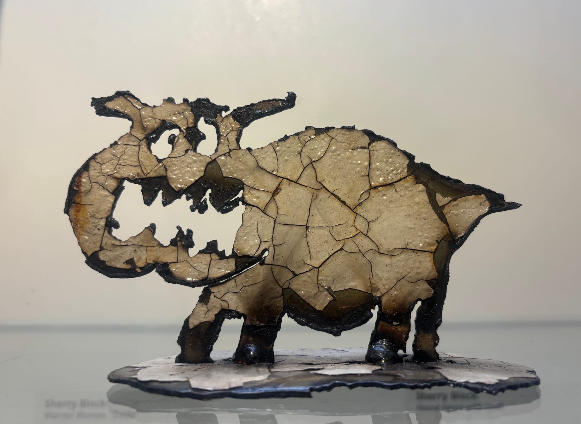 A paint and steel sculpture of a house hippo.