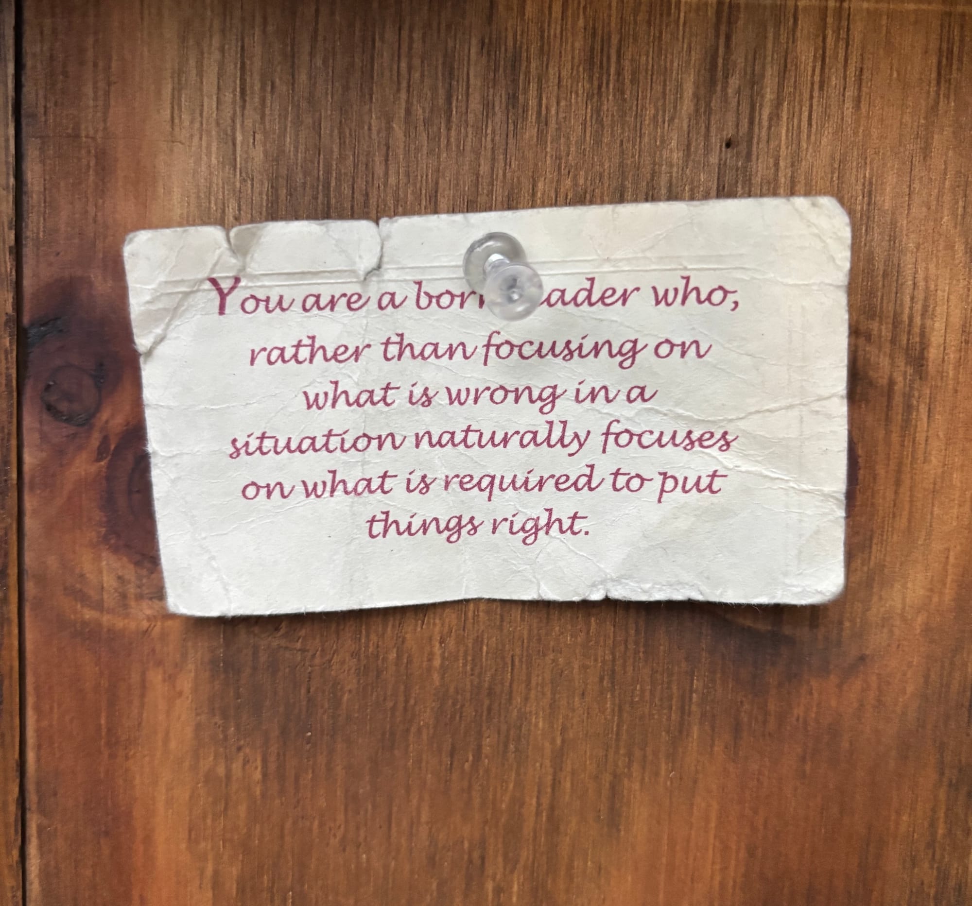 A note tagged onto the side of the library: "You are a born leader who, rather than focusing on what is wrong in a situation naturally focuses on what is required to put things right."