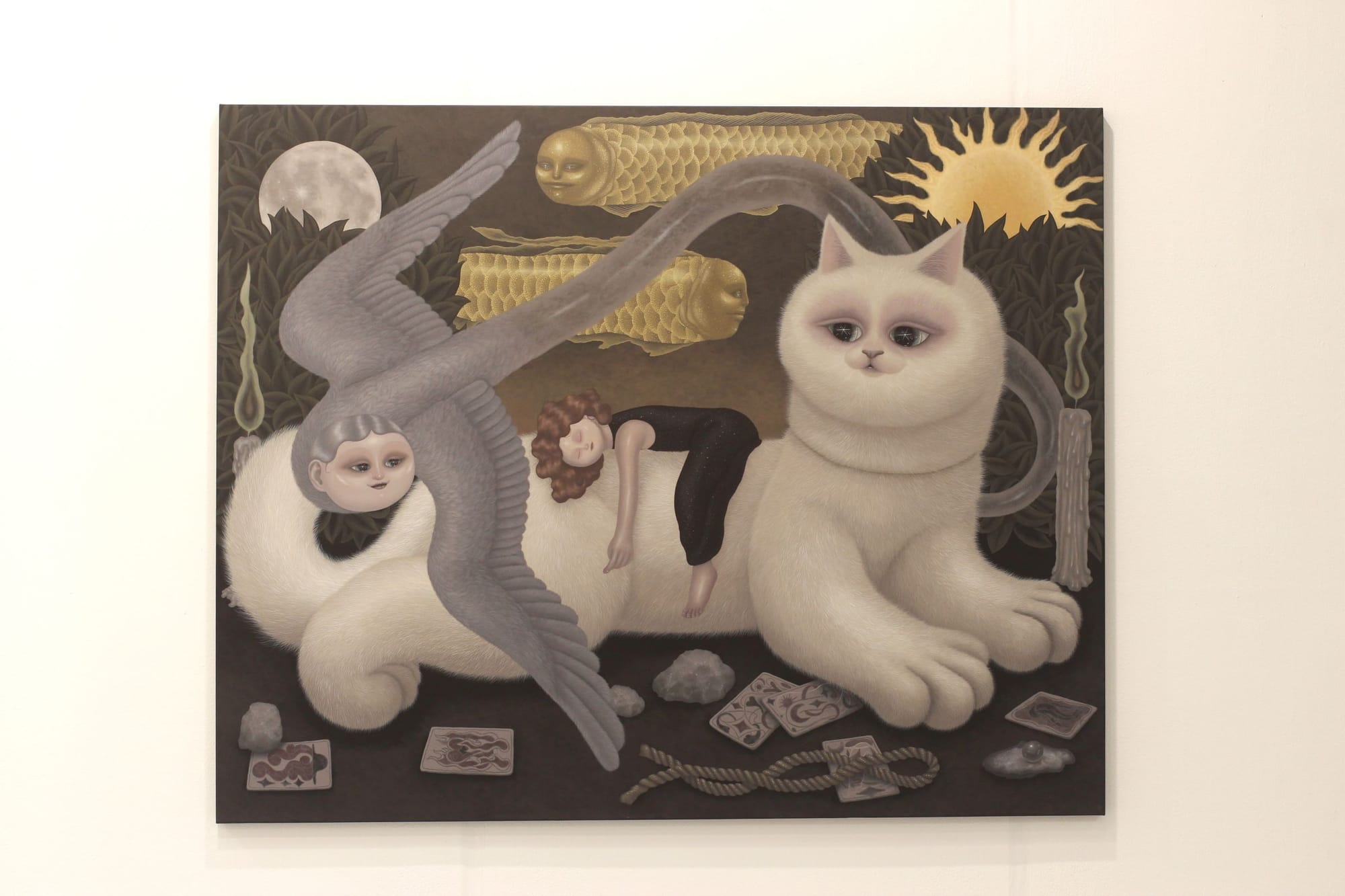 A surrealist, illustrative painting of creatures like fish with human gaces, a flying serpentine creature, and a huge white cat. A girl is sleeping on the cat. There is a spiky sun.