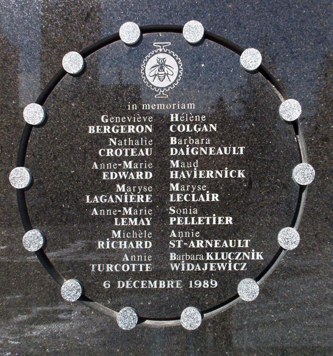 a marble and stone plaque with the names of the 14 women murdered on 6 December 1989 carved on it, surrounded by a circle with 14 smaller circles representing each of the women