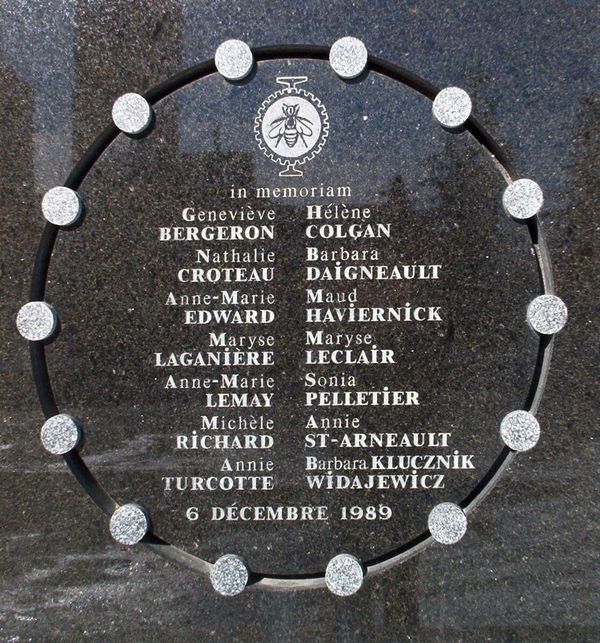a marble and stone plaque with the names of the 14 women murdered on 6 December 1989 carved on it, surrounded by a circle with 14 smaller circles representing each of the women