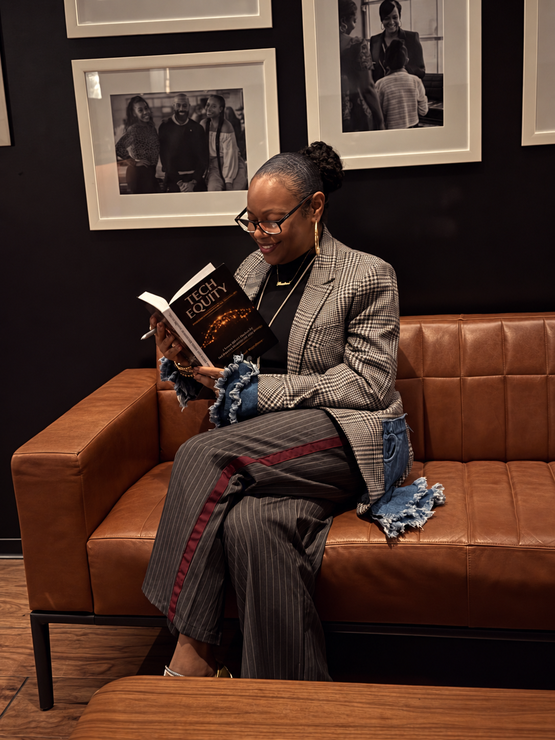 Precious “Preciosa” Myers-Brown reading Tech Equity on a cognac leather sofa
