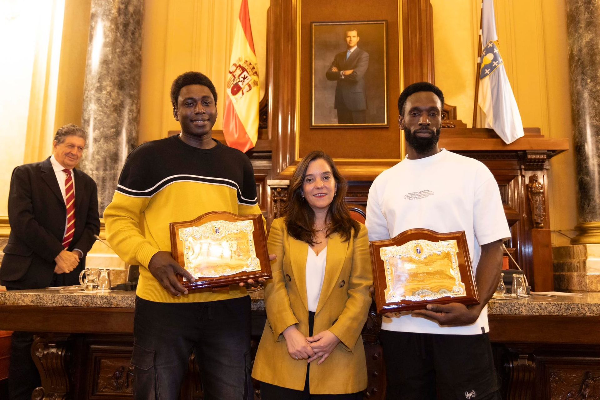 Two Senegalese migrants who attempted to save the life of a gay man beaten to death in Spain have been honoured for their heroic actions