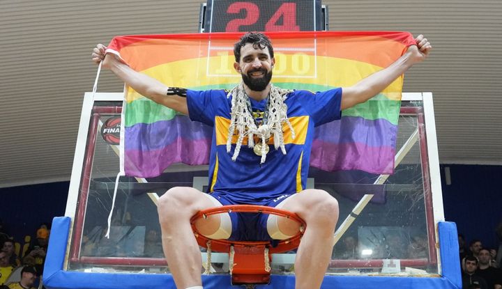 Argentina’s first openly gay basketball  player, Sebastián Vega, celebrates  team victory by unfurling LGBTQ+ Pride Flag
