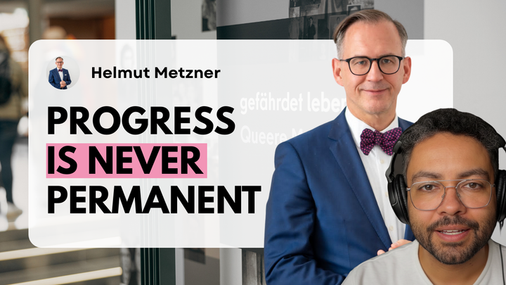 YouTube thumbnail for the Still Here podcast showing Helmut Metzner in a blue suit and bow tie beside host Leslie Clarke wearing headphones. Bold text reads “Progress Is Never Permanent”.