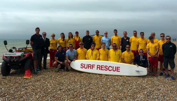 Cllr Alan Robins (Labour, South Portslade) with the new lifeguard team. Photographer Alan Steeden