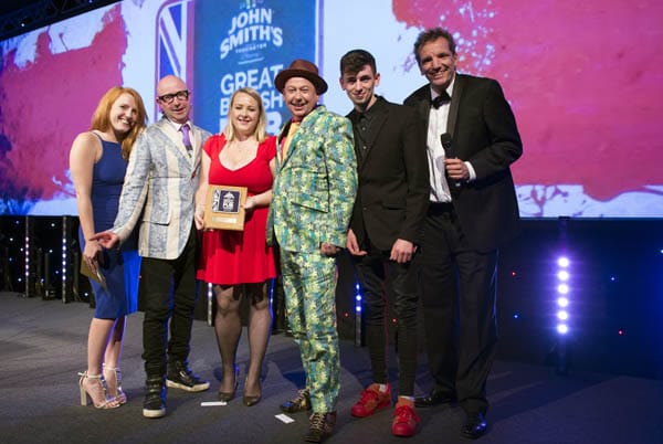 German comedy ambassador Henning Wehn presents the award to the Roebuck Inn team