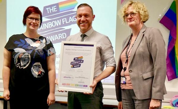 Georgina Clarke-Green (Assistant Director of BHCC), Anna Spragg (Equalities Manager of BHCC) presents Adam Smith (Senior Student Manager at BACA) with the school’s Rainbow Flag Award
