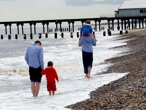 George and Martin with their children at the beach