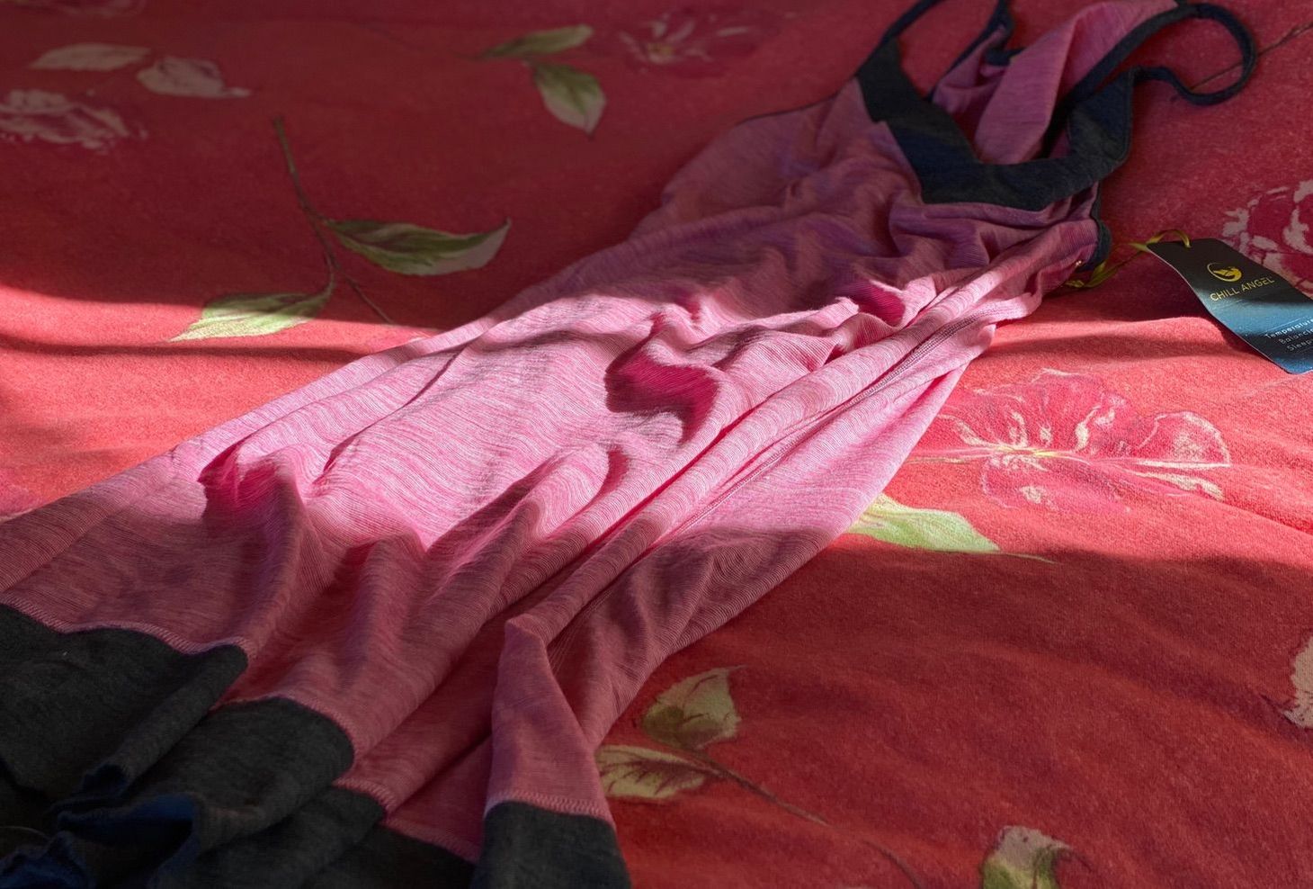 A pink and gray nightgown draped on a cozy flannel-topped wool comforter.