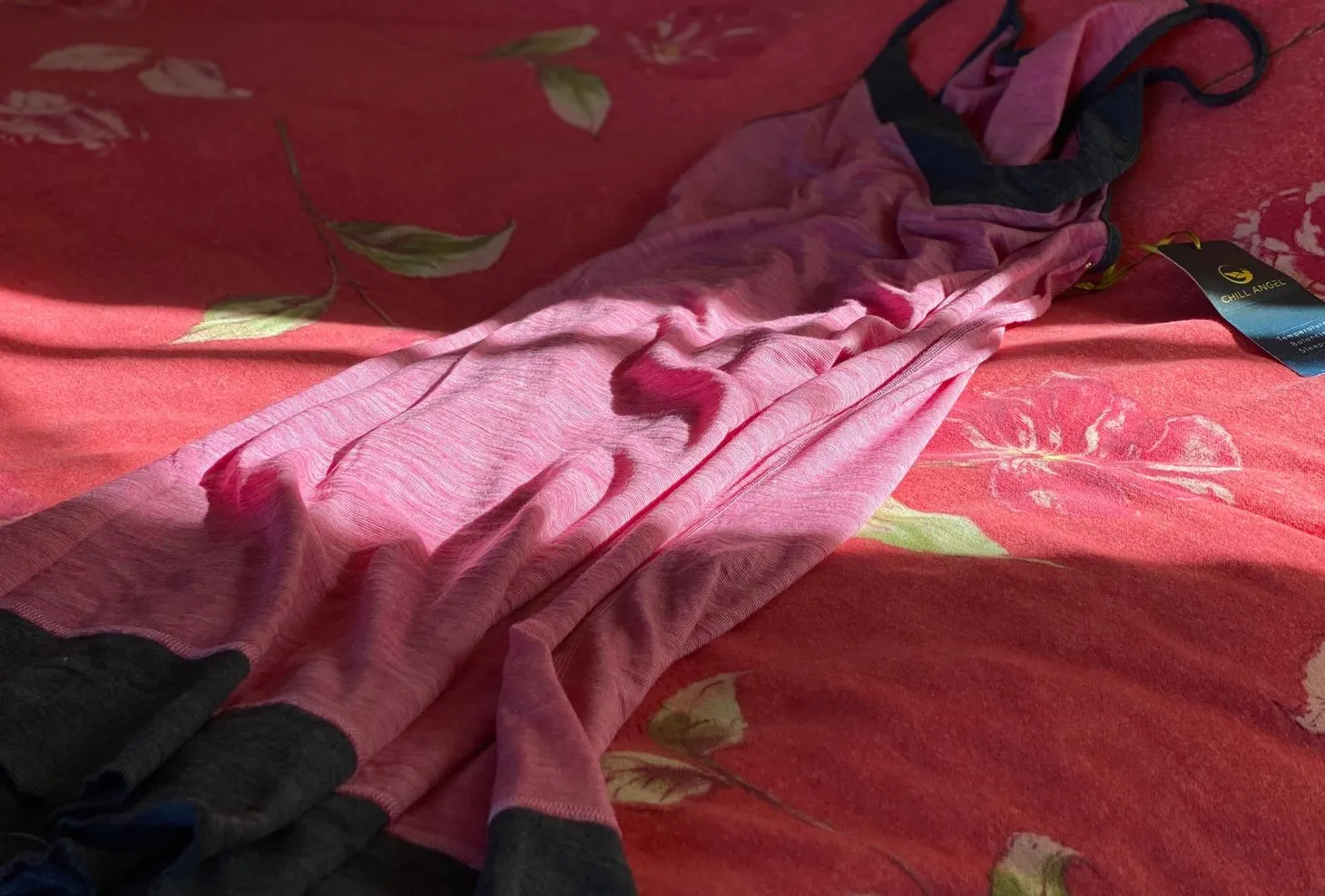 A pink and gray nightgown draped on a cozy flannel-topped wool comforter.