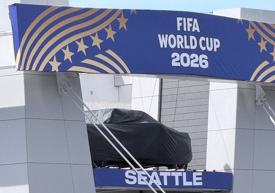 A picture of the south end of Lumen Field, which usually has a display with a car. For the World Cup, the car is covered up with a black sheet.