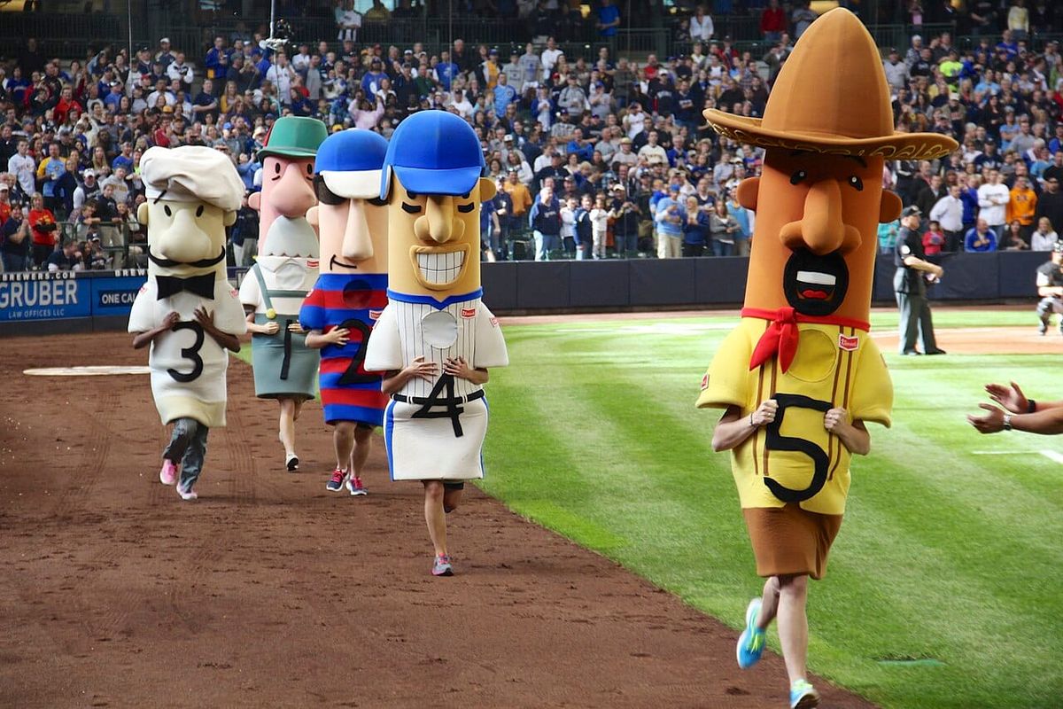 A picture of the sausage race at a Brewers game.