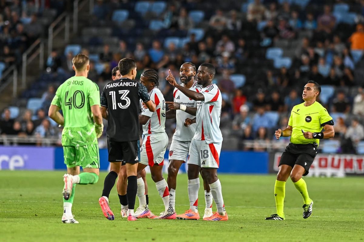 Anthony Markanich argues with FC Dallas defenders. Image credit: Dan Mick