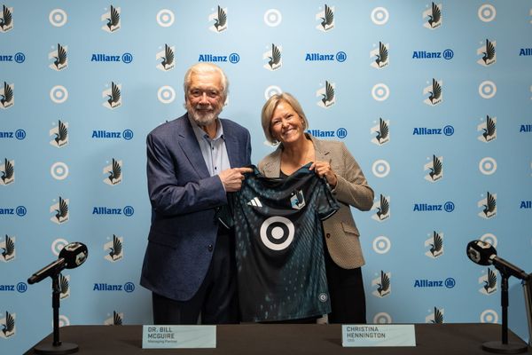 New Minnesota United FC CEO Christina Hennington and team managing partner Dr. Bill McGuire pose with a Loons jersey at an introductory press conference