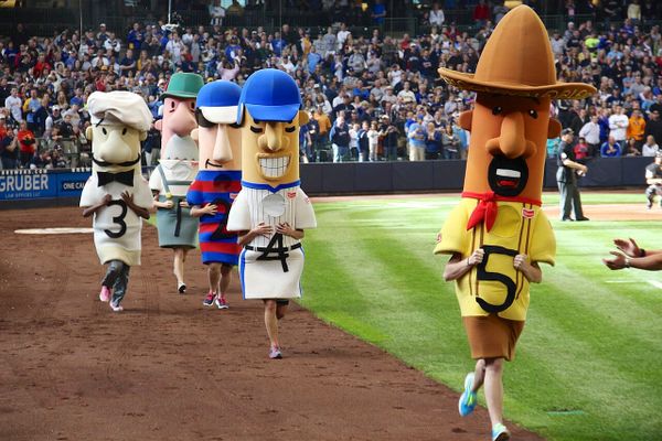 A picture of the sausage race at a Brewers game.
