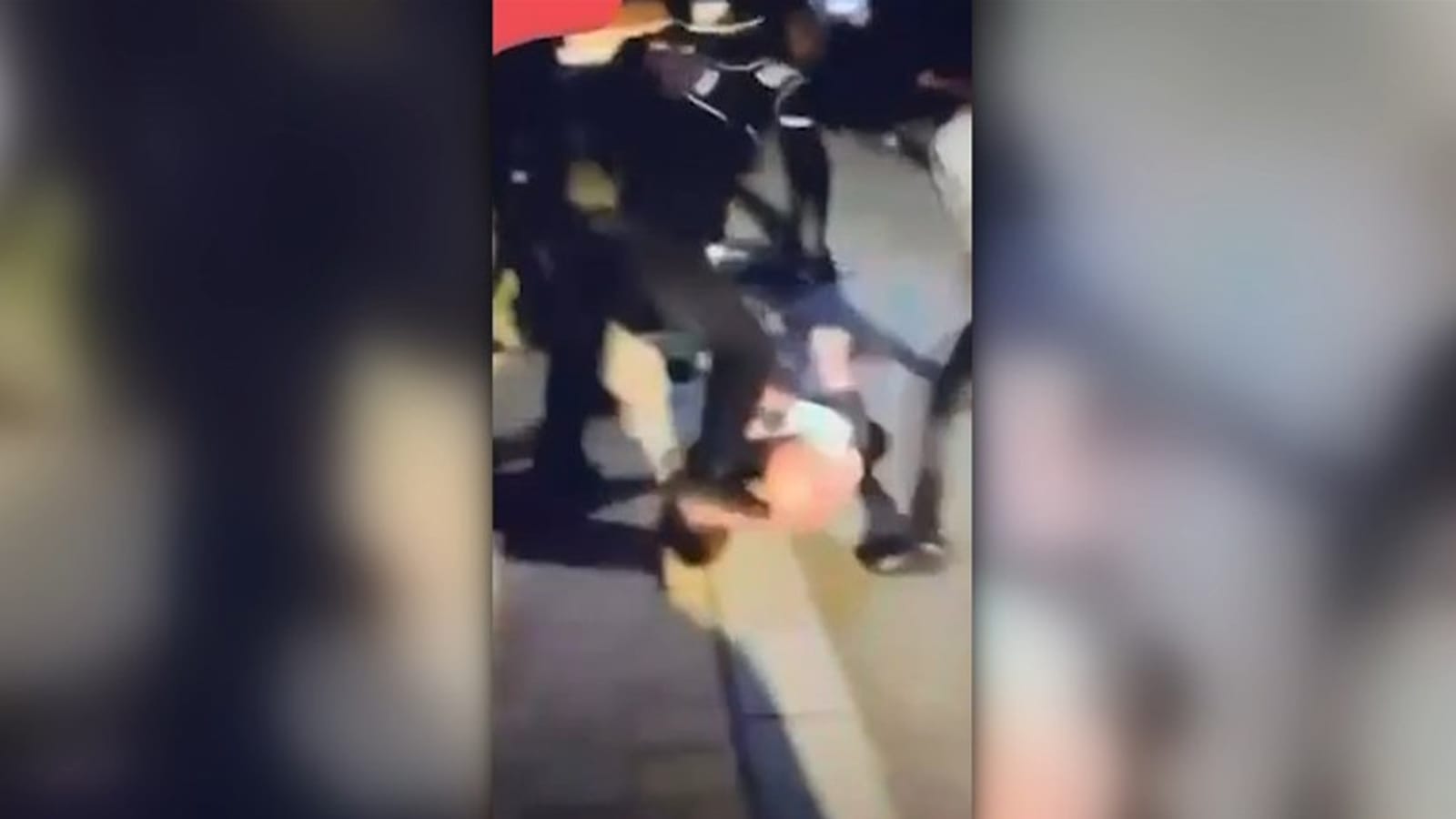 Attackers kick and stomp a teenager lying on the road