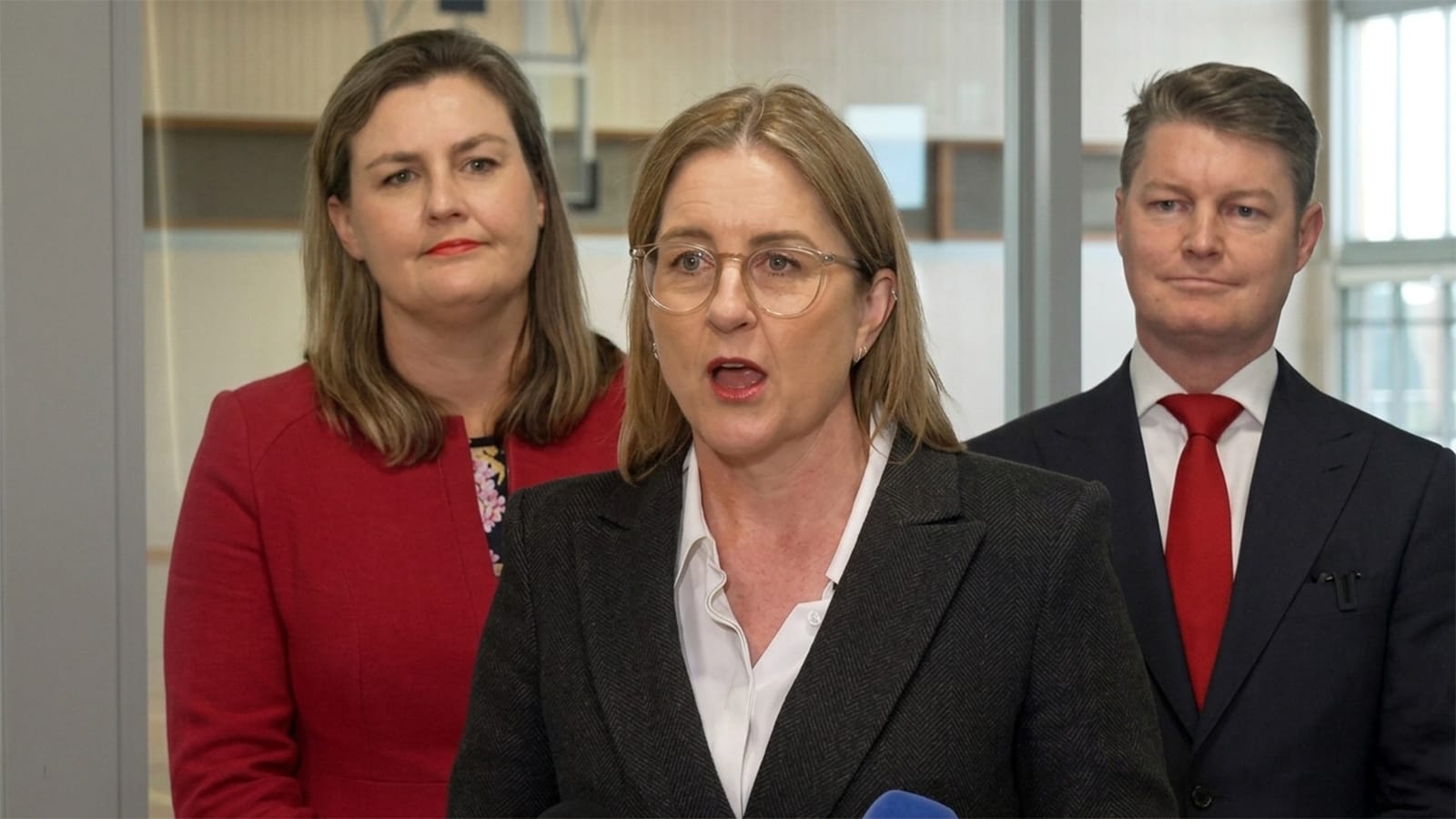 Jacinta Allan speaking to media with Ben Carroll standing behind her