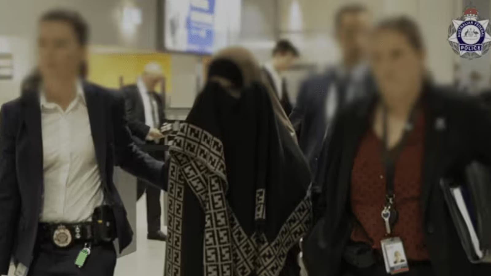 Kawsar Abbas escorted by Australian Federal Police officers