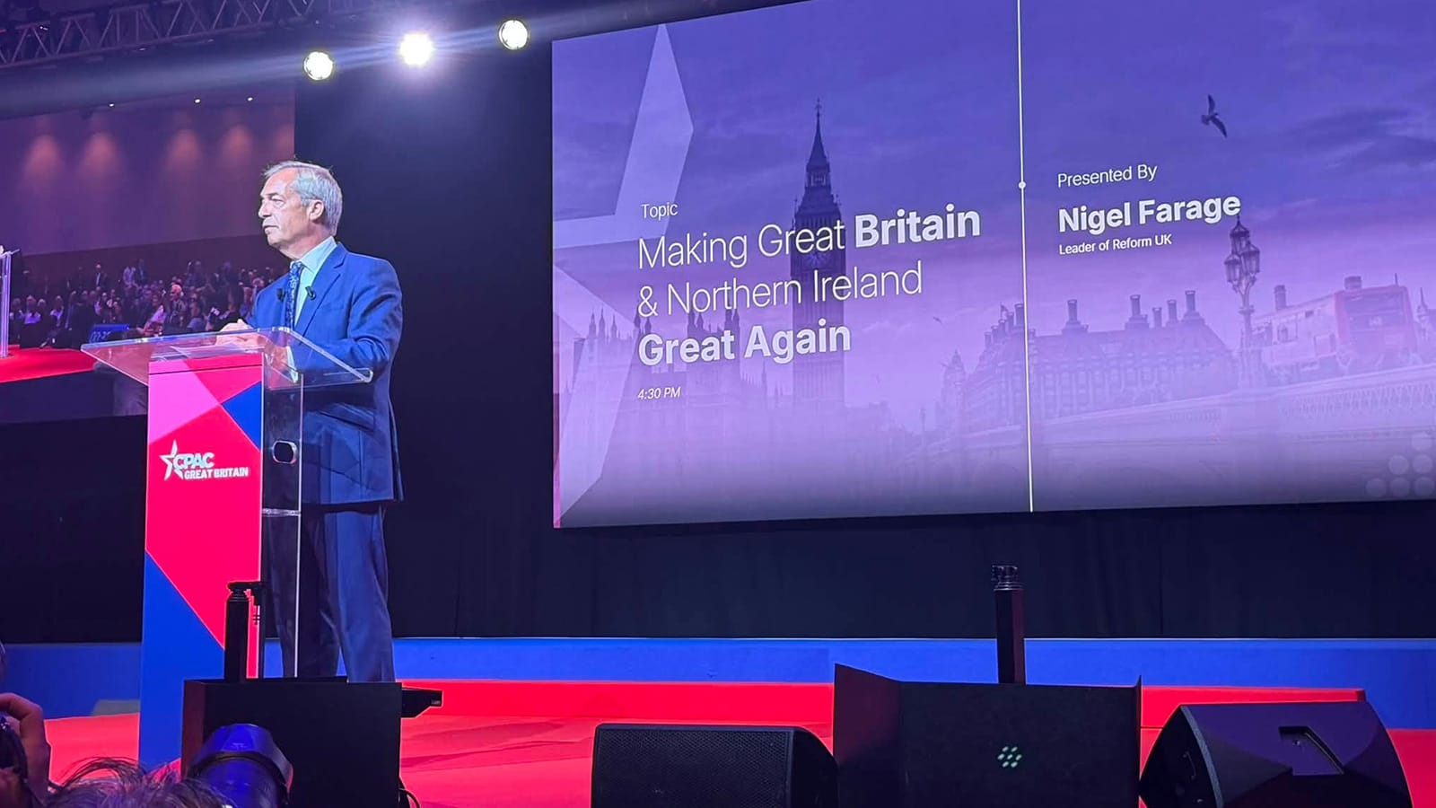 Nigel Farage speaking on stage at CPAC London conference