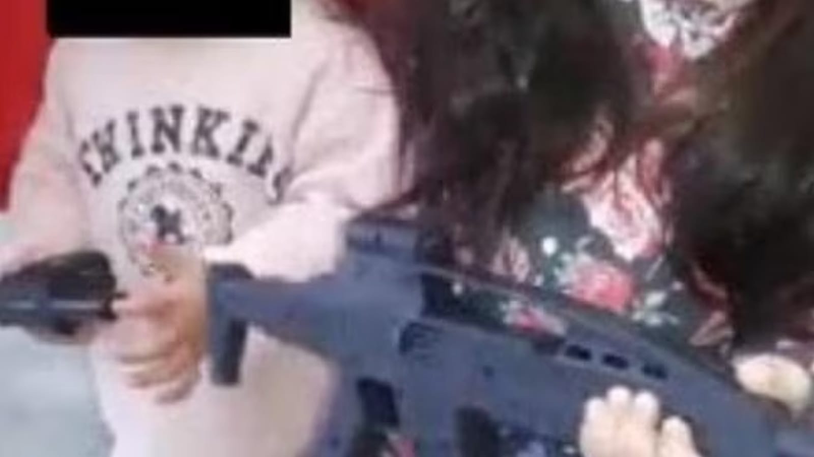 A still from footage tendered in court showing a child holding a toy rifle