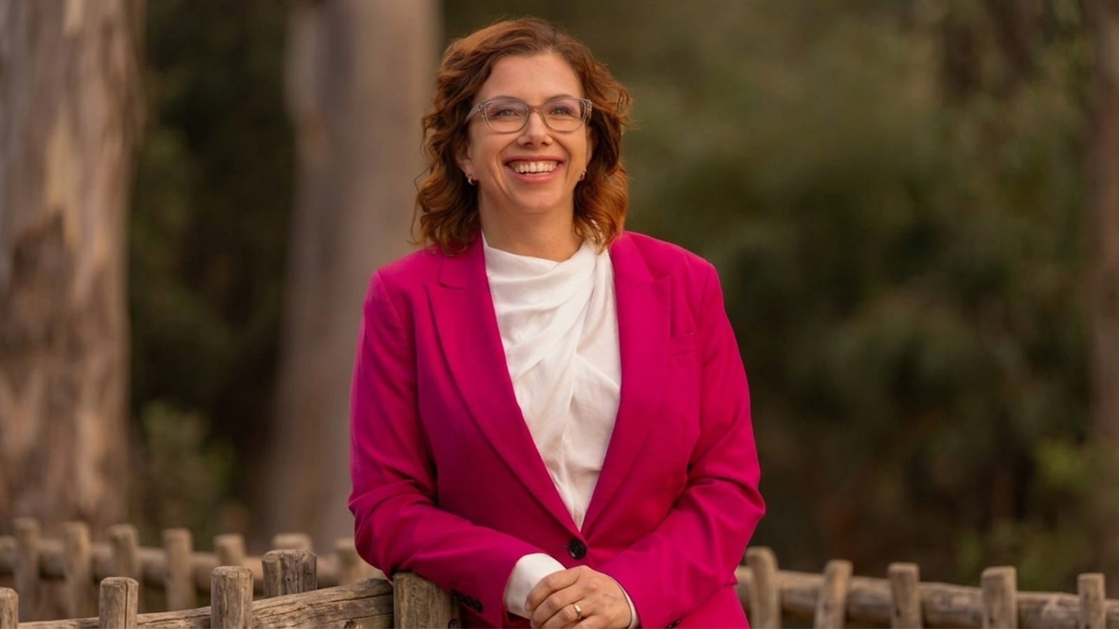 Amanda Rishworth in a pink suit photographed outdoors