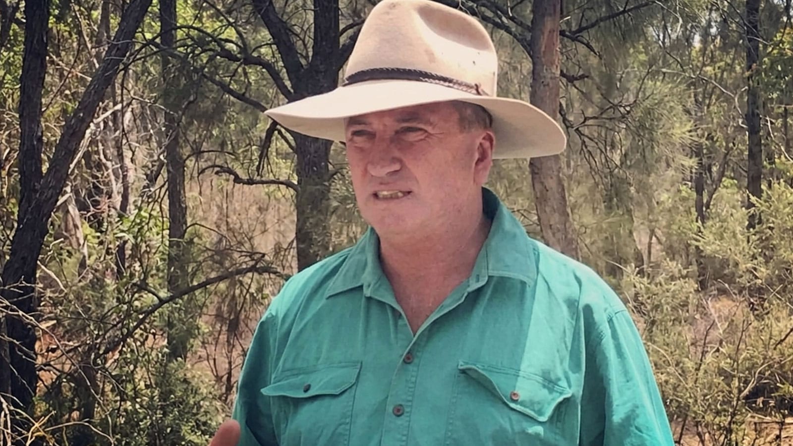 Barnaby Joyce in a wide brim hat speaking outdoors in bushland