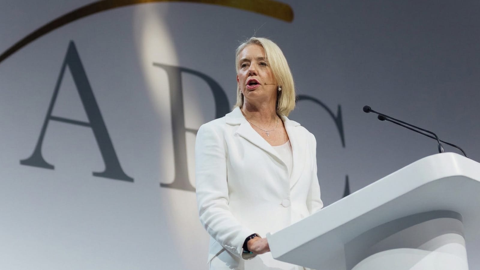 Bridget McKenzie speaking at a lectern wearing a headset microphone