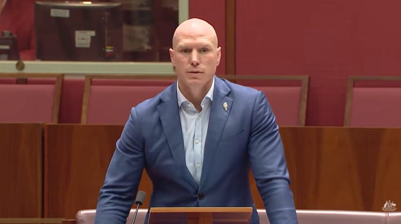 David Pocock standing in the Senate chamber introducing a bill