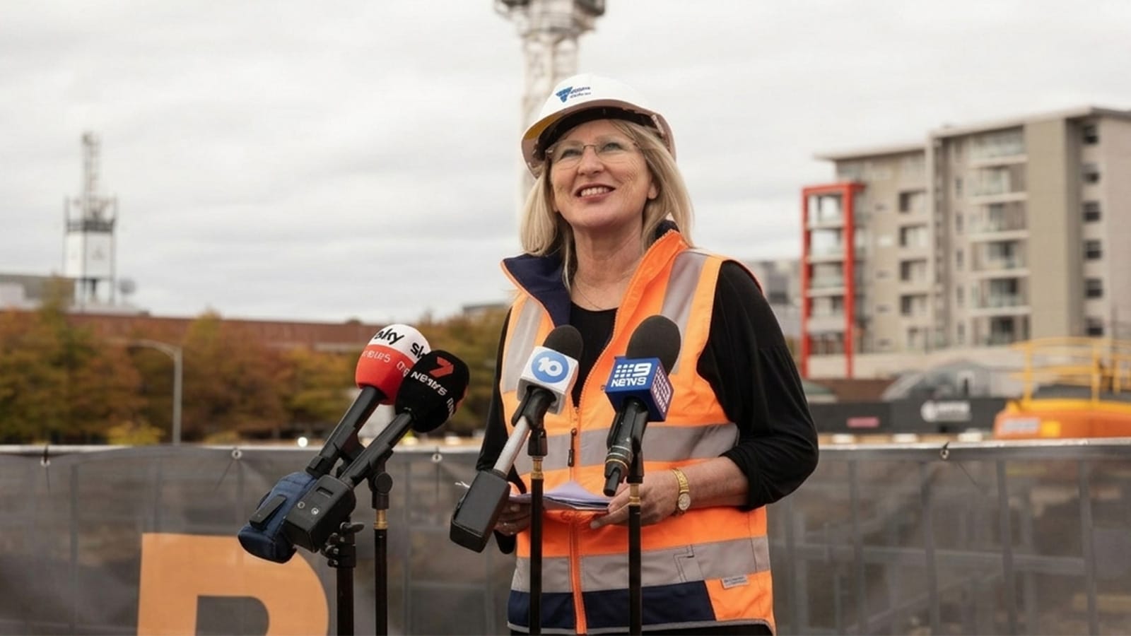 Gayle Tierney in hard hat and hi vis at a press conference