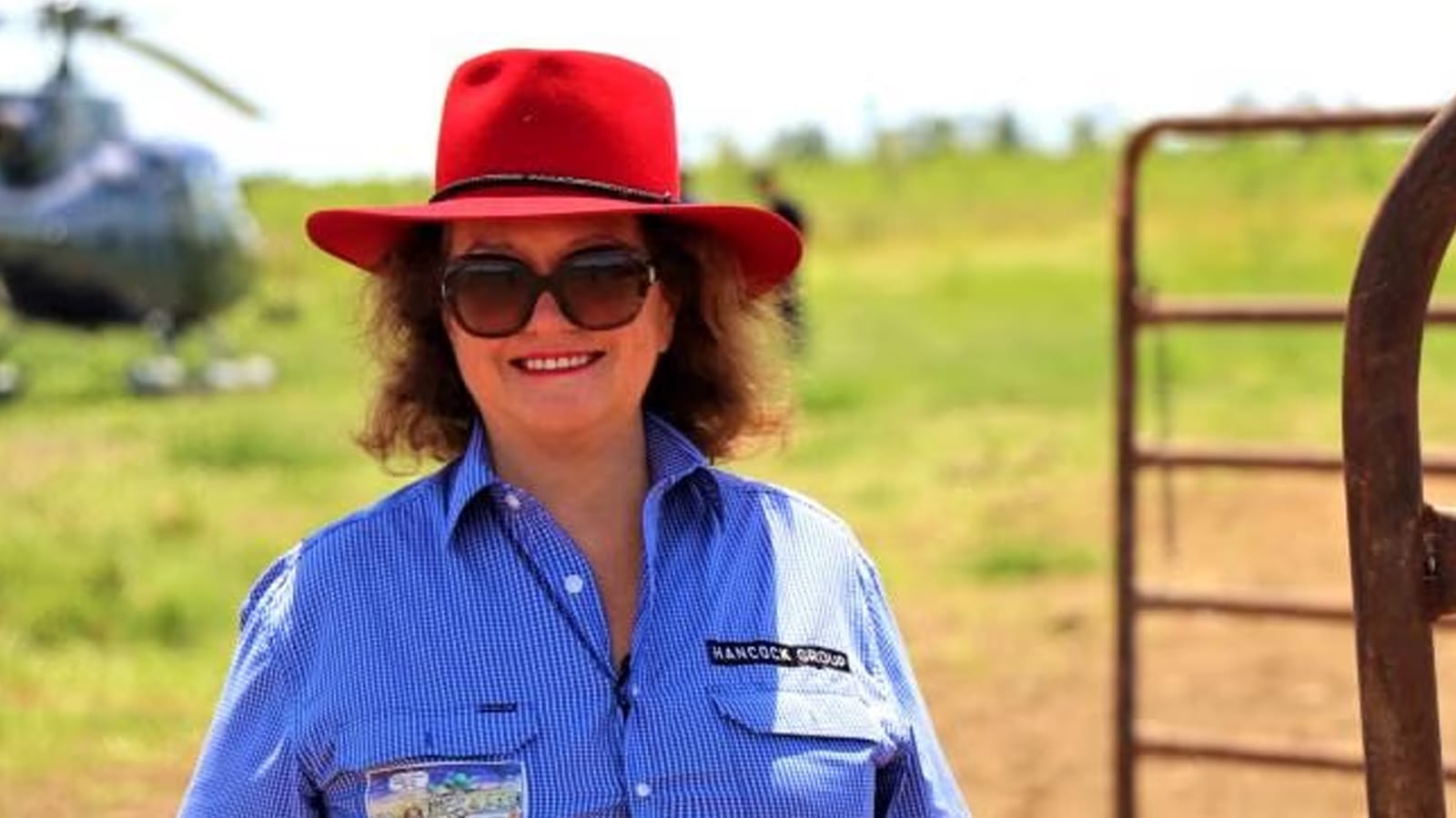 Gina Rinehart in a red hat and Hancock Group shirt on a station