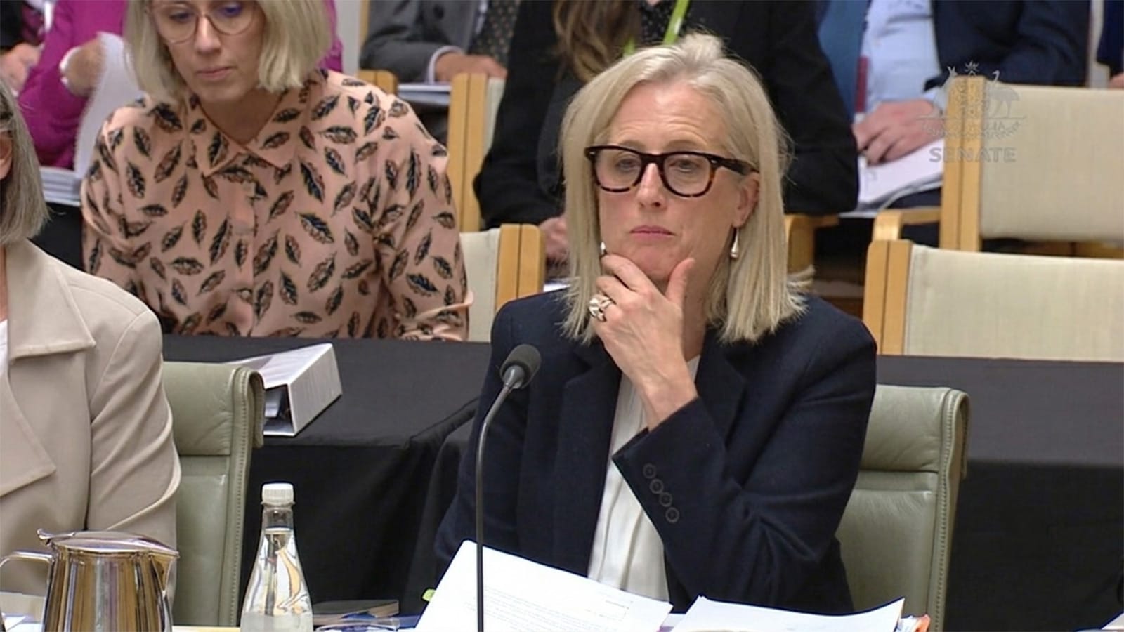 Katy Gallagher seated with papers in the Senate chamber