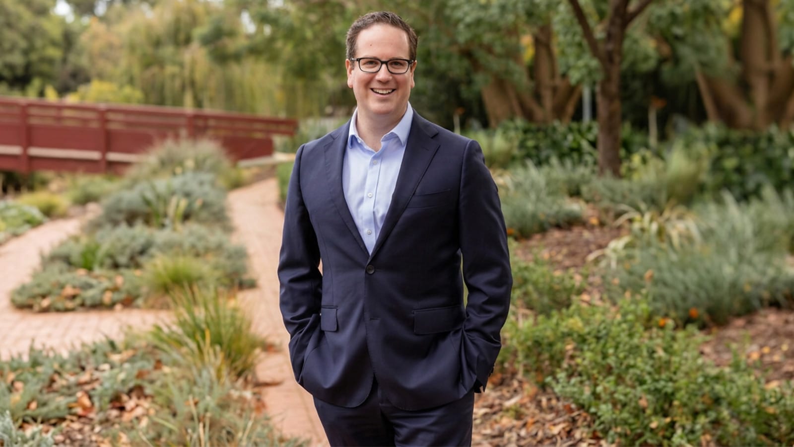 Matt Keogh standing in a garden wearing a navy suit