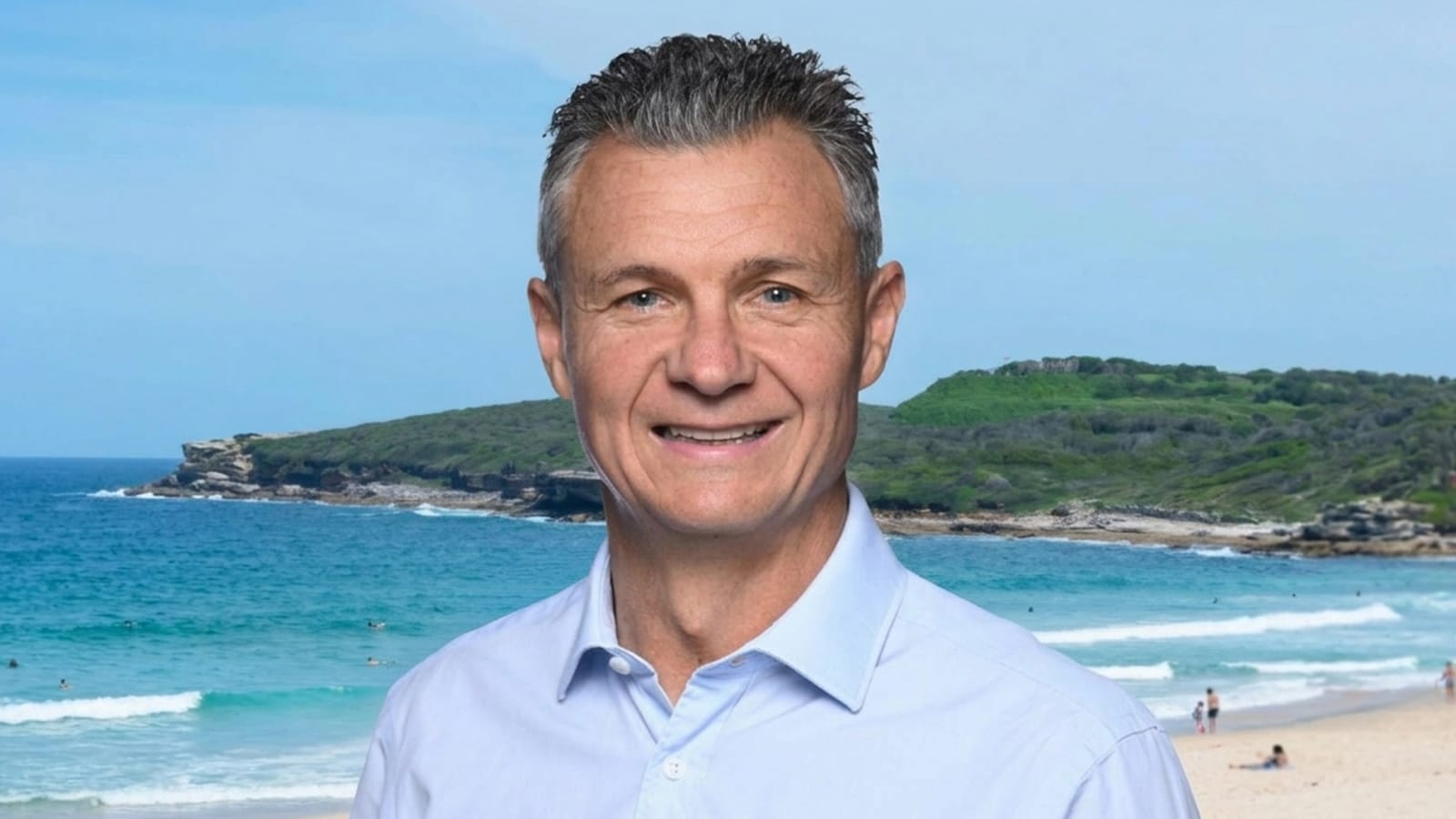 Matt Thistlethwaite smiling in a light blue shirt at a beach