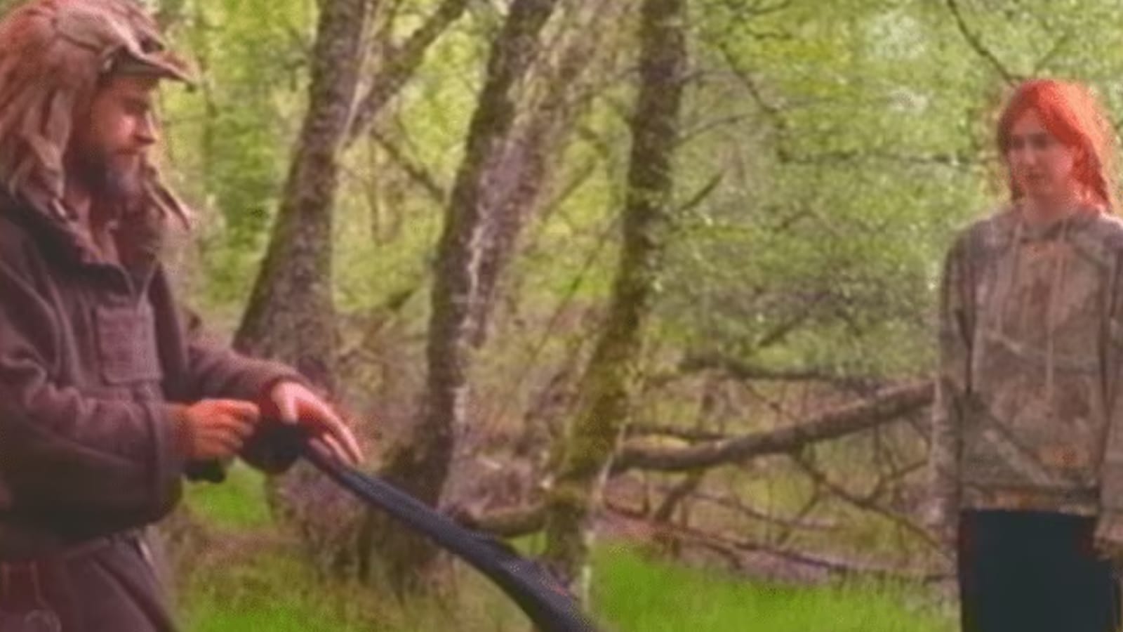 Scene from Race Around the World showing a man sharpening a stick