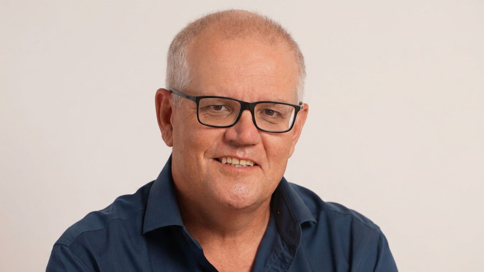 Scott Morrison in a blue shirt against a plain background