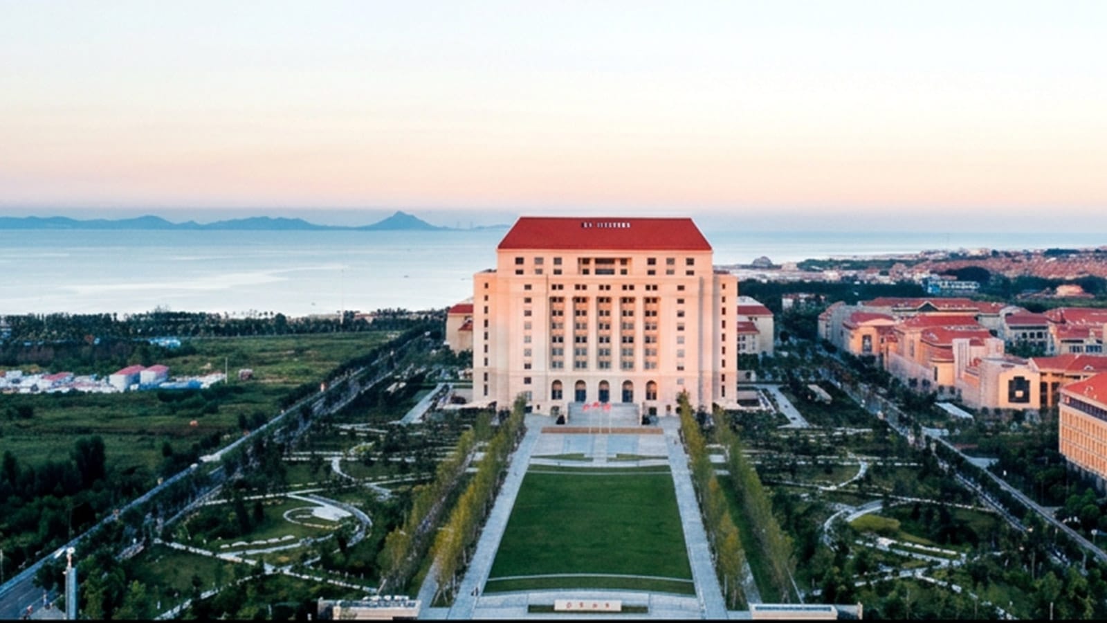 Aerial view of a Shandong University campus building beside the coast.