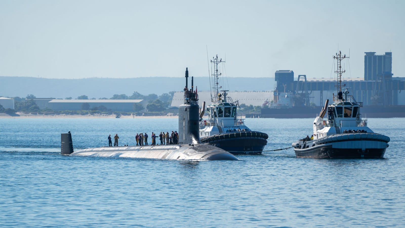 US Navy submarine with crew on deck arriving at HMAS Stirling