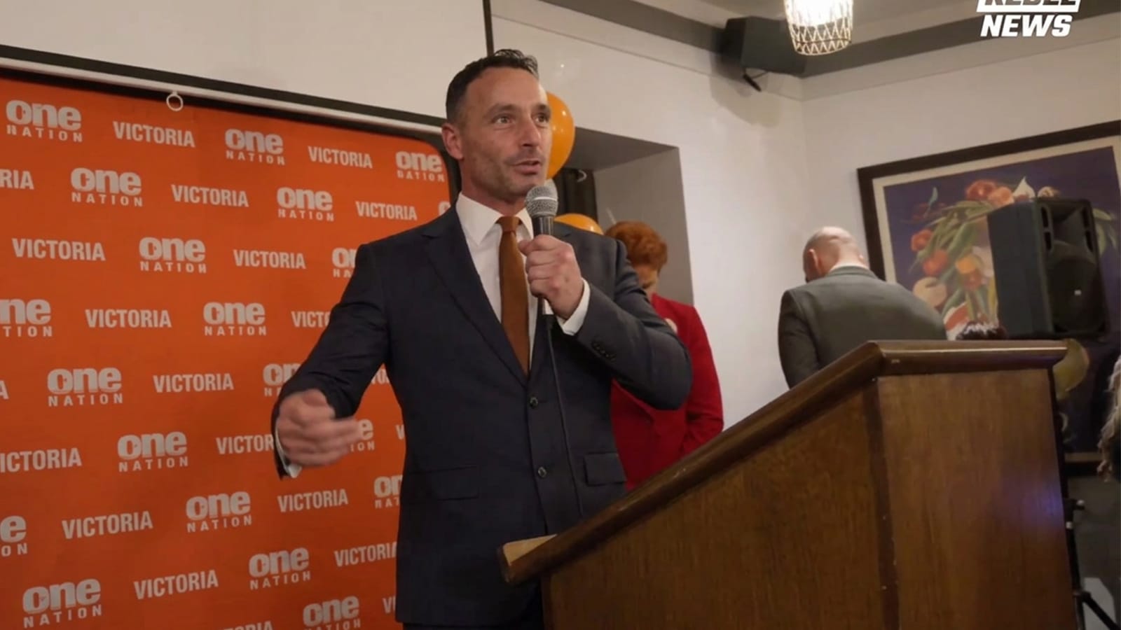 Warren Pickering speaking into a microphone at a One Nation Victoria event