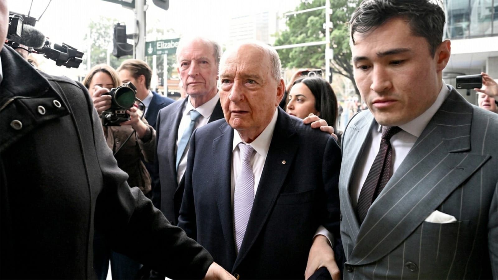 Alan Jones arrives at the Downing Centre court through a media scrum