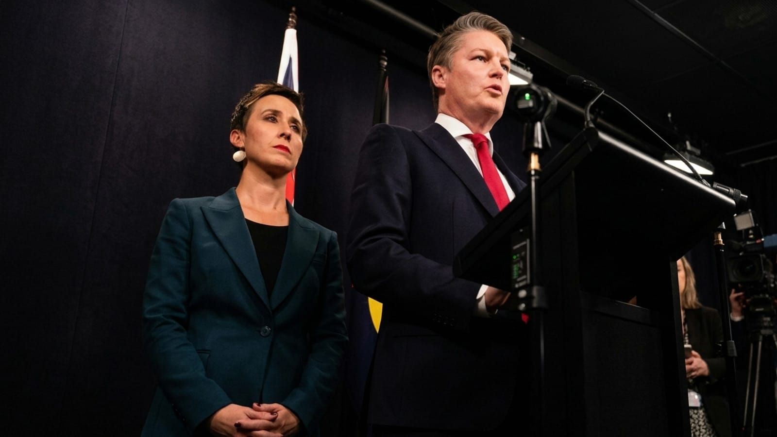 Ben Carroll speaking beside Gabrielle Williams at a Melbourne press conference