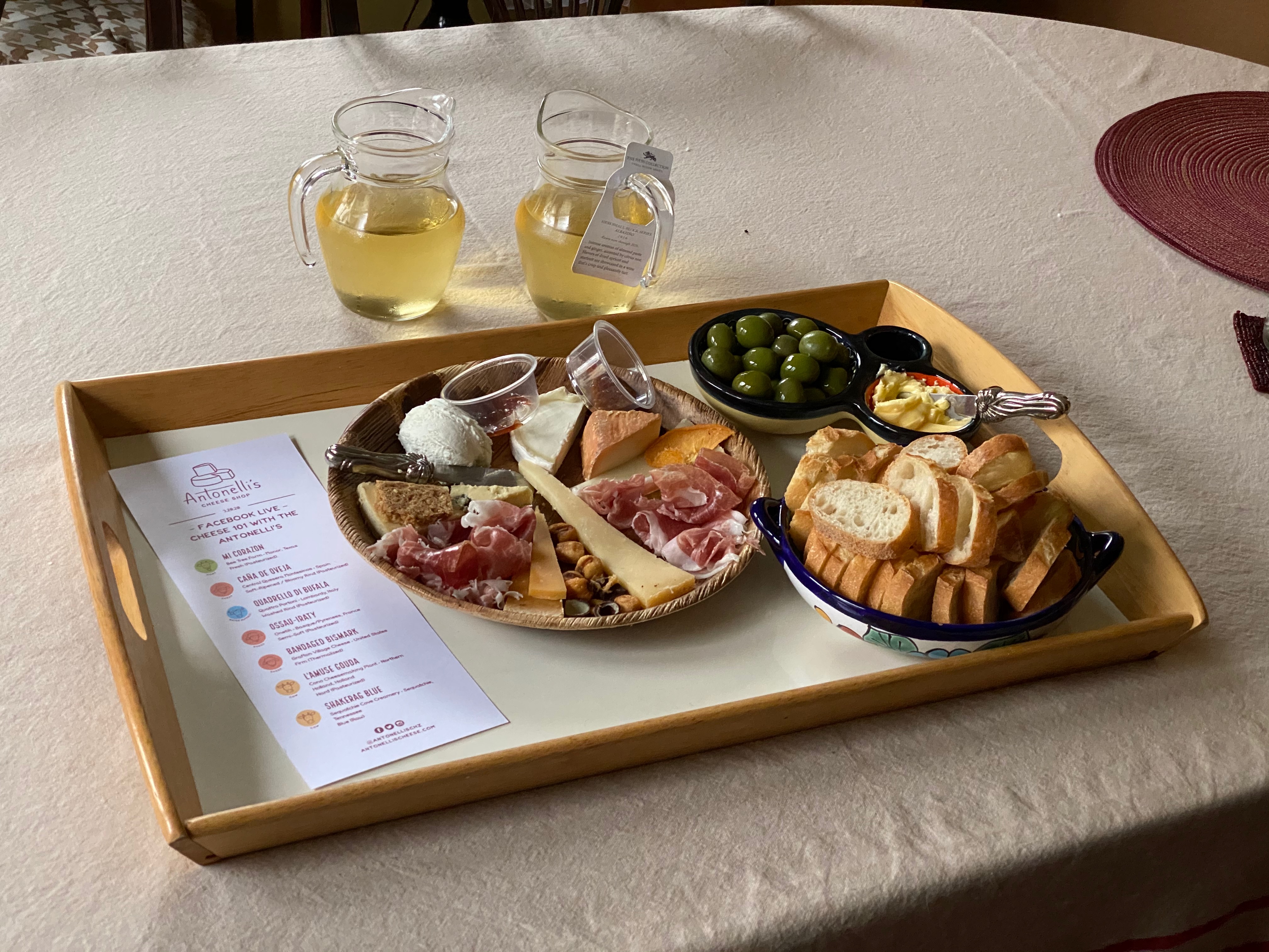 A cheese plate with wine and bread.