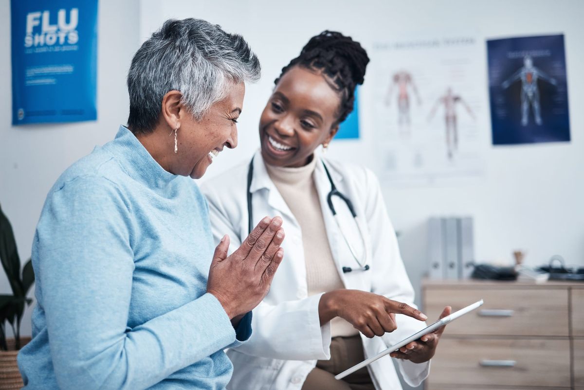 Doctor engaged in friendly talk with older patient